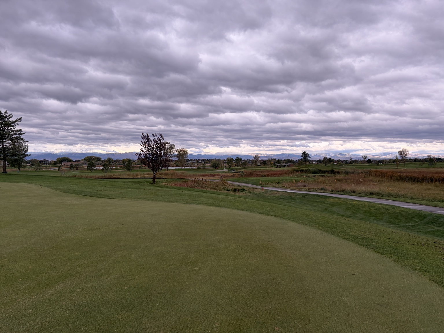 Storm clouds above Saddleback Golf Club and the Colorado mountains.
