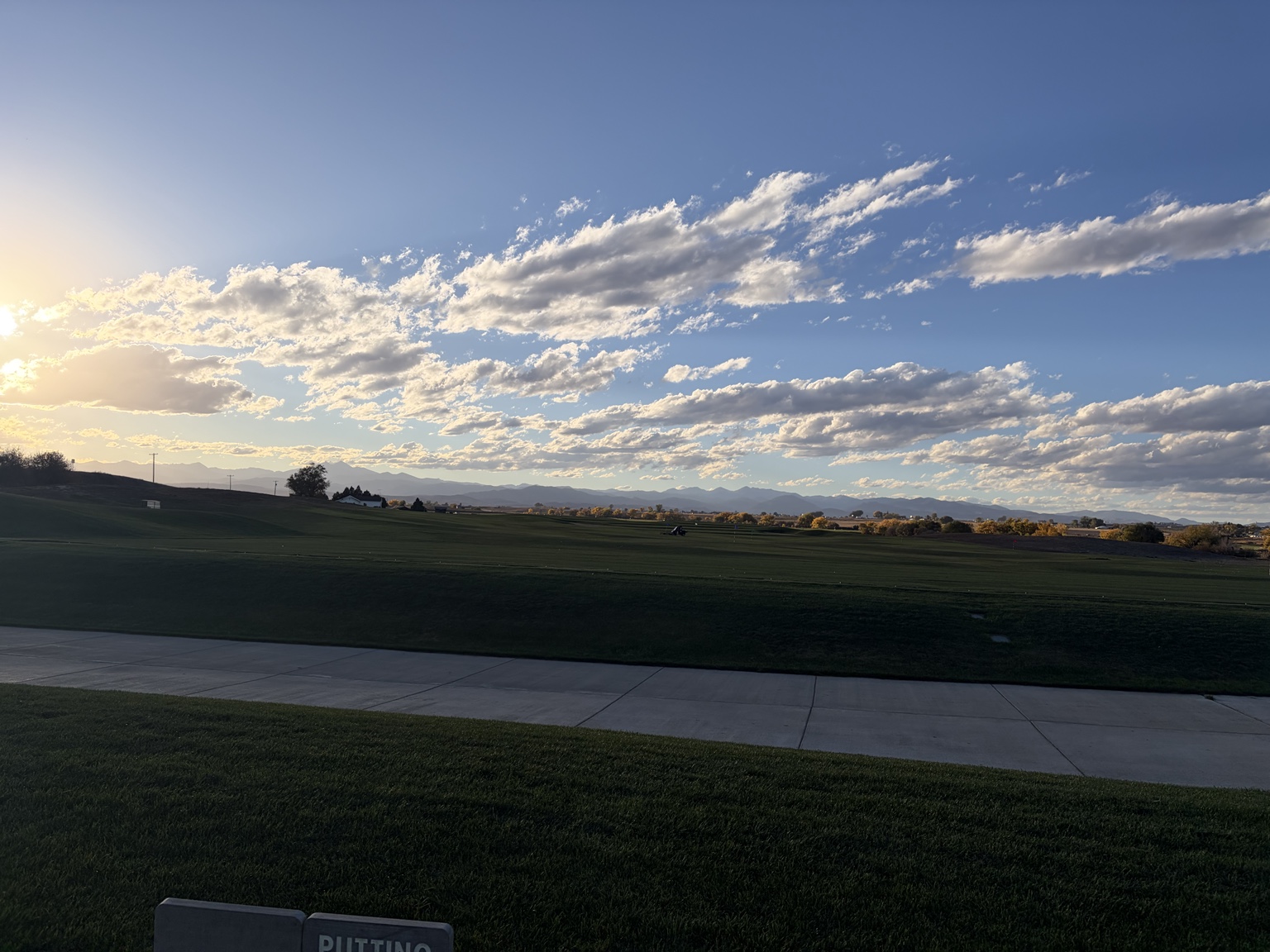Morning light, clouds and distant mountains across Ute Creek Golf Course.